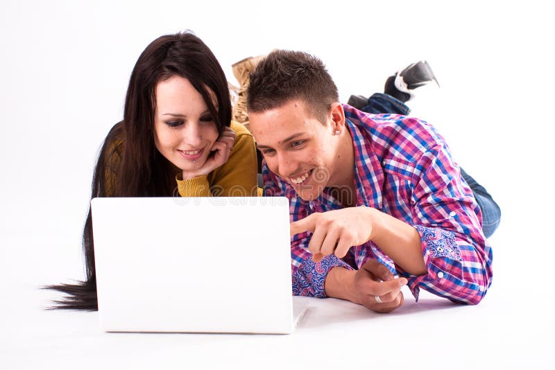 Teen girl and boy with white laptop