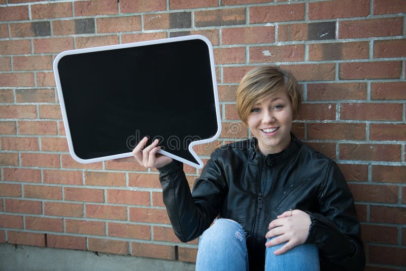 Teen girl holds black sign royalty free stock photos Teen girl holds black sign royalty free stock photos