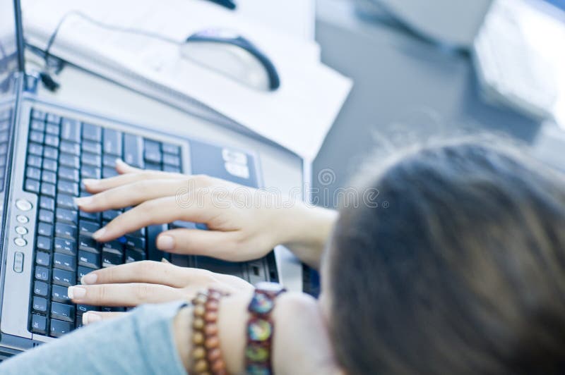 Teen girl learning computers from her sister