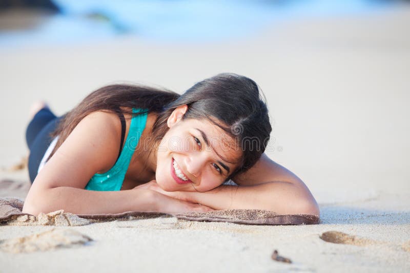 Teen Girl Lying Down On Sandy Beach, Head On Arms Stock ...