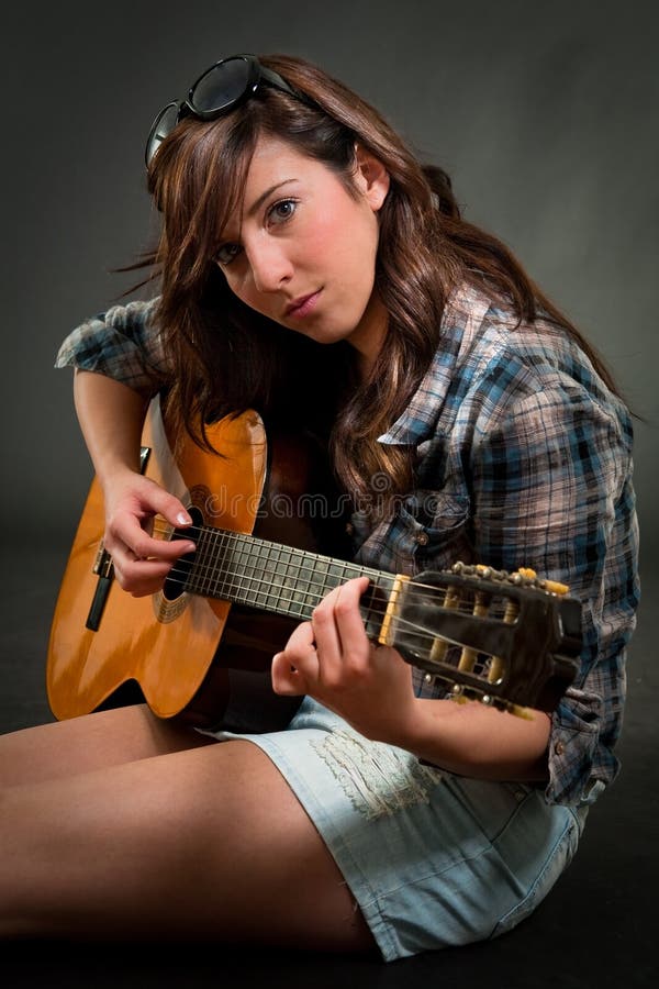 Teen girl playing guitar