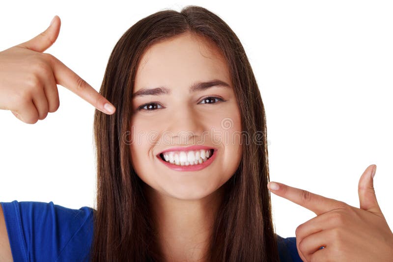 Teen girl pointing on her perfect teeth stock images Teen girl pointing on her perfect teeth stock images