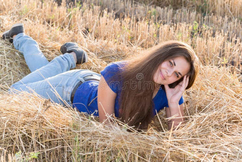 Teen girl resting in a field