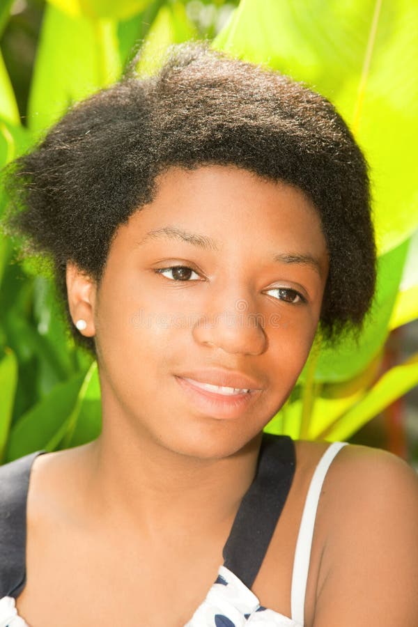 Teen Girl is Sitting in the Yard Stock Image