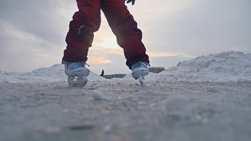 Teen girl skating on ice, winter sunset beautiful view, winter sport holidays