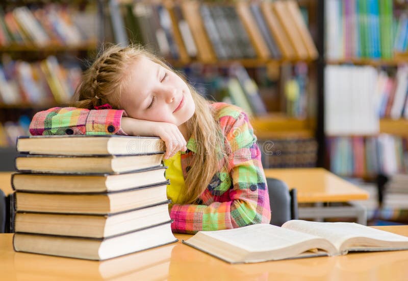Teen girl sleep in library stock images