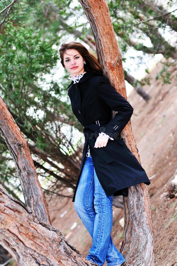 Teen girl standing near the tree