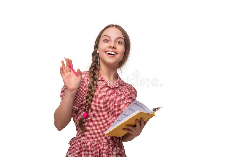 Teen girl writing in school notes. Thinking and taking notes. School girl doing homework isolated on white. Writing in royalty free stock photos