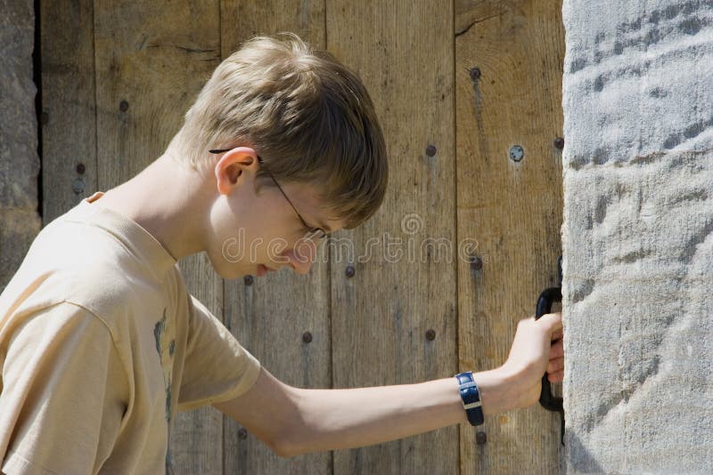 Teen knocking at an old door