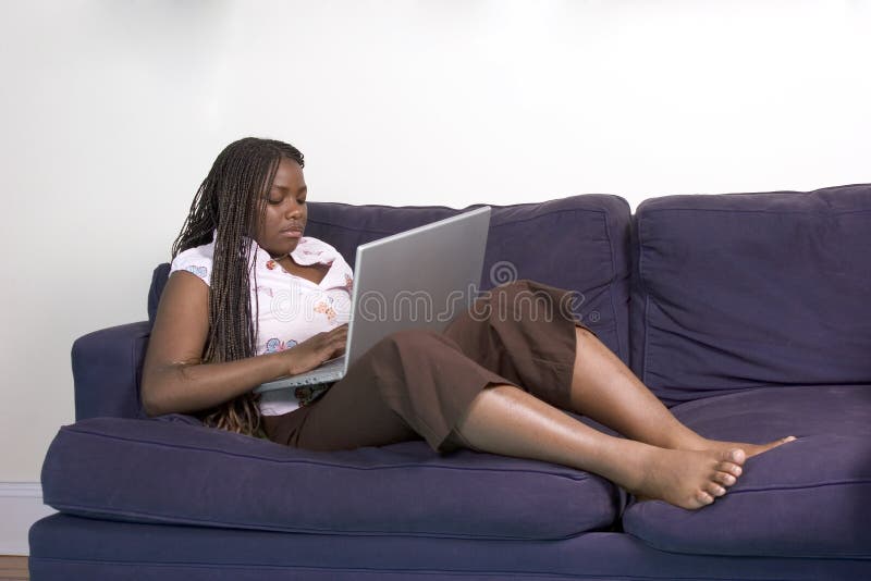 Teen with laptop on the couch