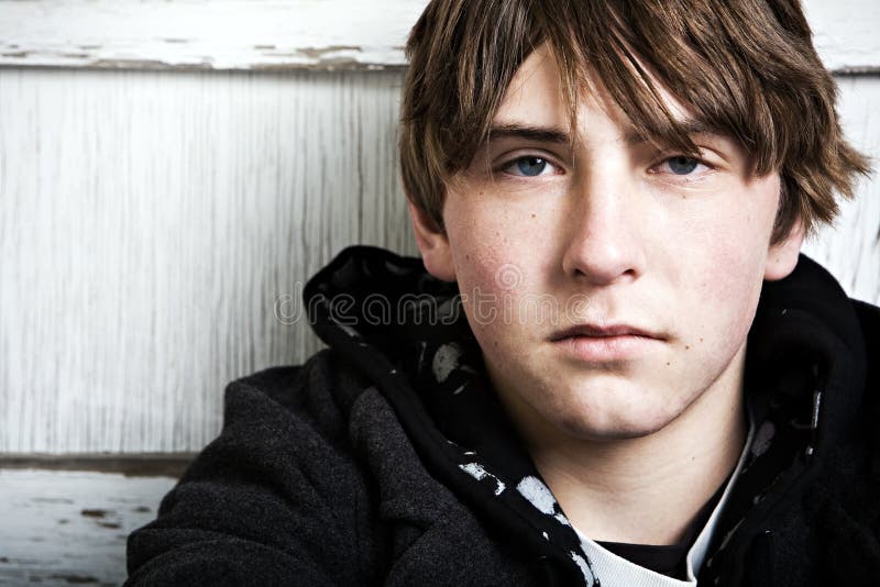 Teen male portrait, expressionless and unshaven, Generation X, closeup with copyspace. Teen male portrait, expressionless and unshaven, Generation X, closeup with copyspace