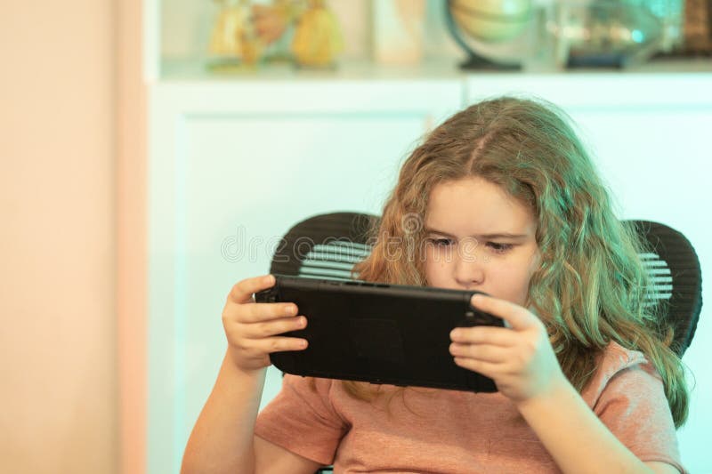 Teen player gaming console. Kid gamer using a digital device. Video gaming. Kid using a game console. Child using game controller stock photography