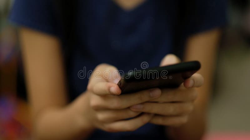 Teen sending message using smart phone