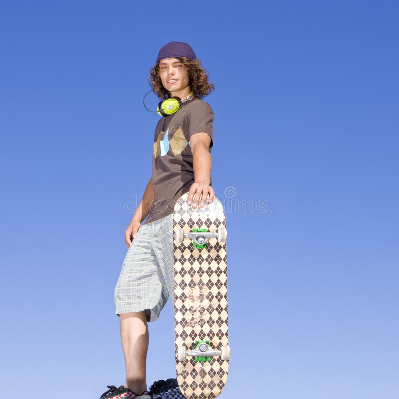 Teen skater atop ramp