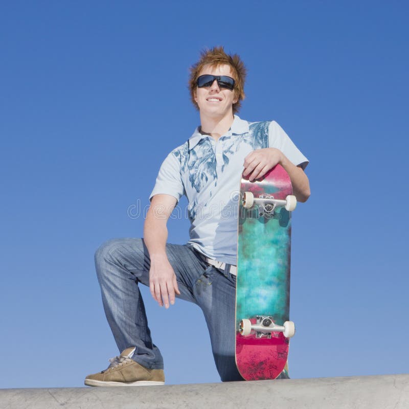 Teen skater atop ramp