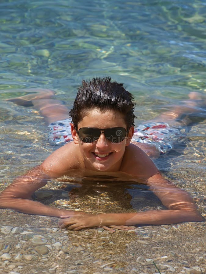 Teen with sunglasses in sea 1