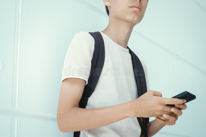 Teen boy distracting from online lesson and playing video games, scrolling  phone. Learning difficulties, online education, entertainment at home Stock  Photo - Alamy