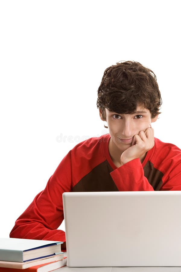 Teenage boy behind desk with laptop royalty free stock photos Teenage boy behind desk with laptop royalty free stock photos