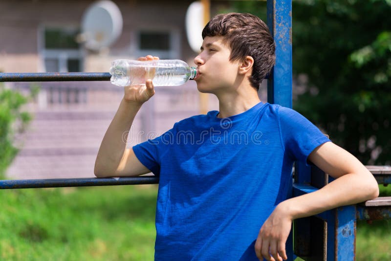 Teen boy with water, Stock image