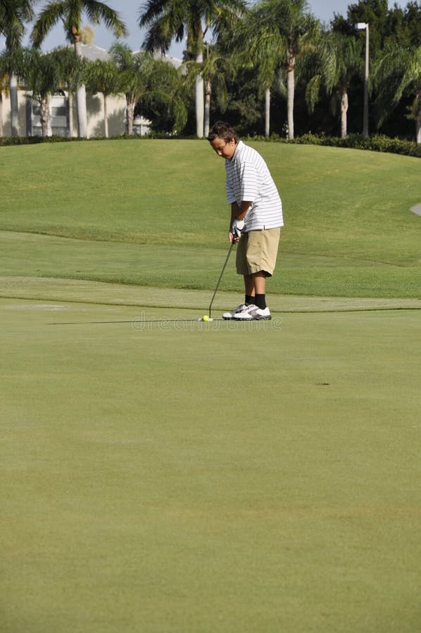 Teenage boy on golf course royalty free stock photos