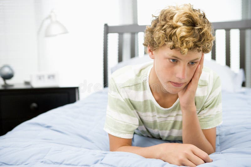 Teenage Boy Lying on Bed stock image. Image of resting 6882651