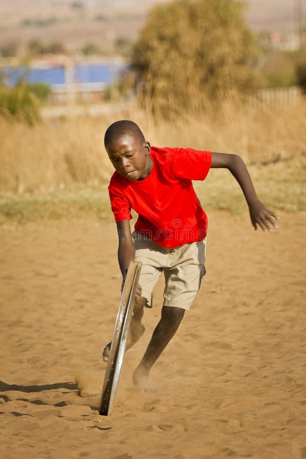 Teenage Boy Playing with Wheel More Action Stock Photo Image of ethnic, sand 25793150