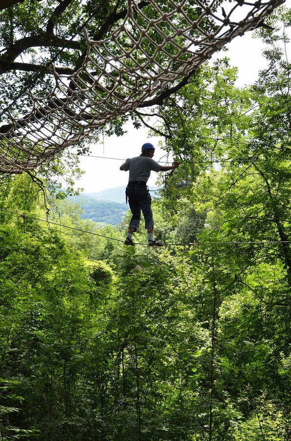 Teenage boy at the rope parkour high up royalty free stock image Teenage boy at the rope parkour high up royalty free stock image