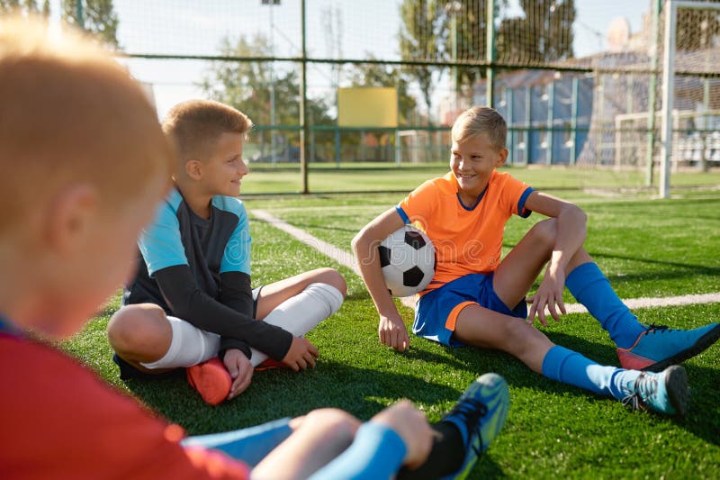Teenage Boys Football Team Talking on Soccer Field Stock Photo Image