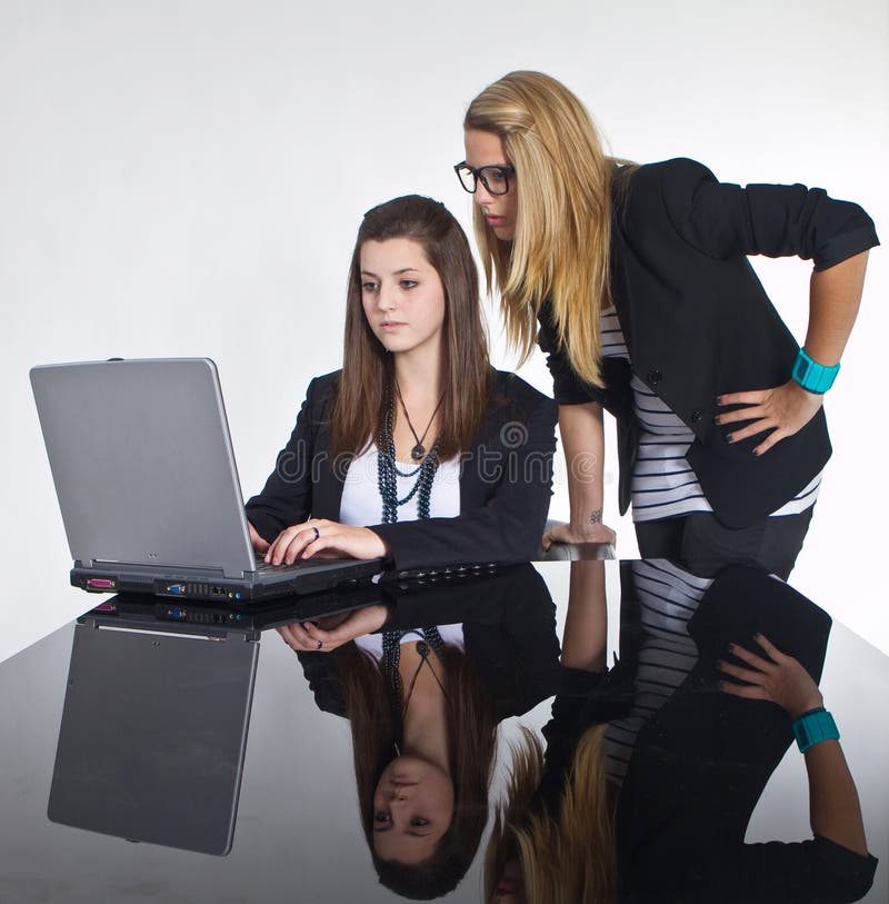 Teenage business girls working on black table