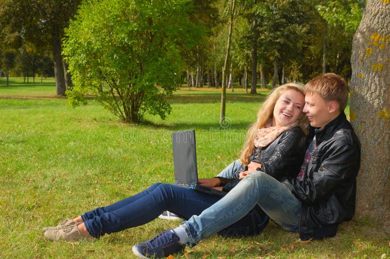 Teenage Couple Studying With A Laptop In The Park Stock Image Image
