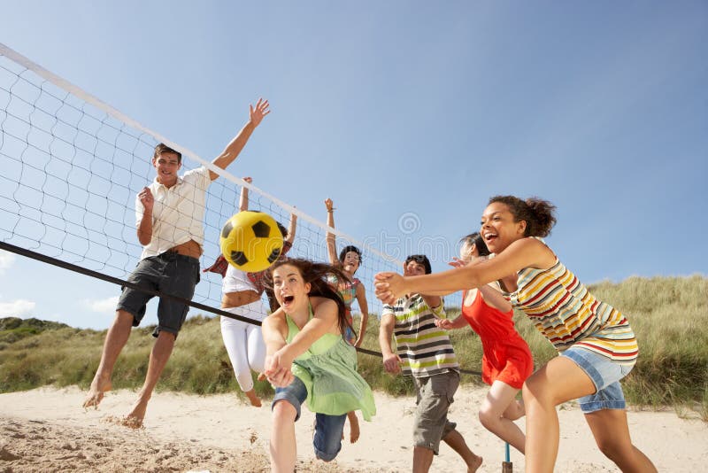 Teenage Friends Playing Volleyball On Beach