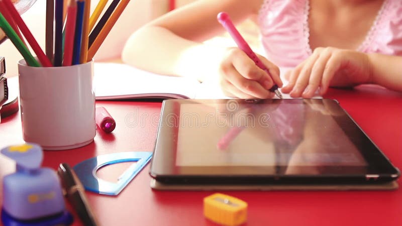 Teenage girl doing homework on tablet computer