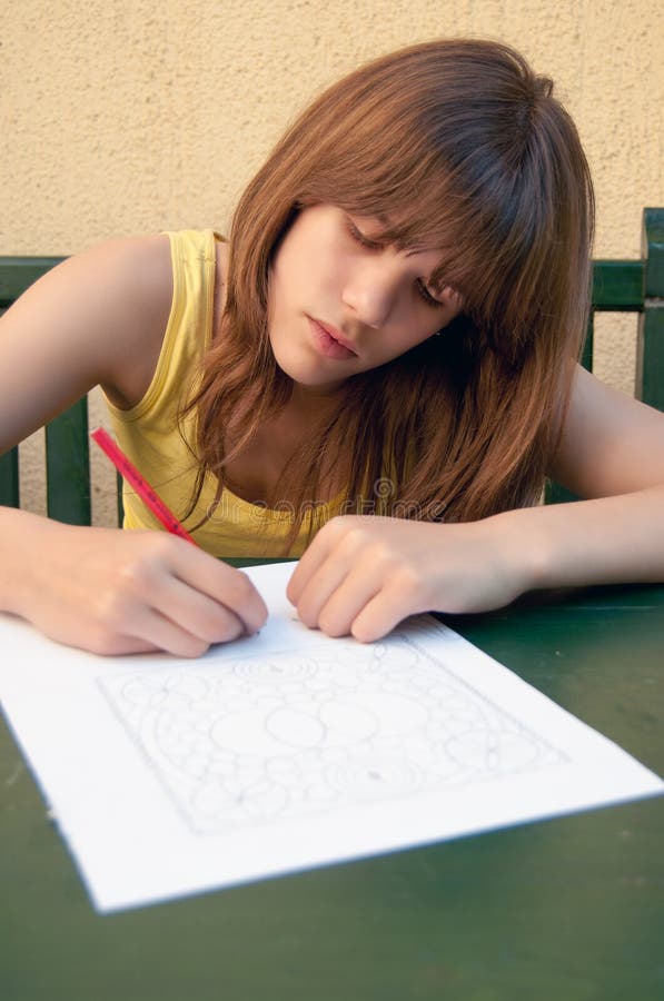 Teenage girl drawing on the paper