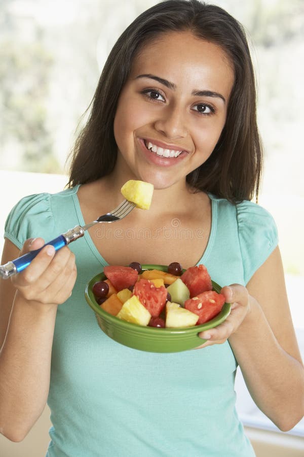 Teenage Girl Eating Fresh Fruit Salad