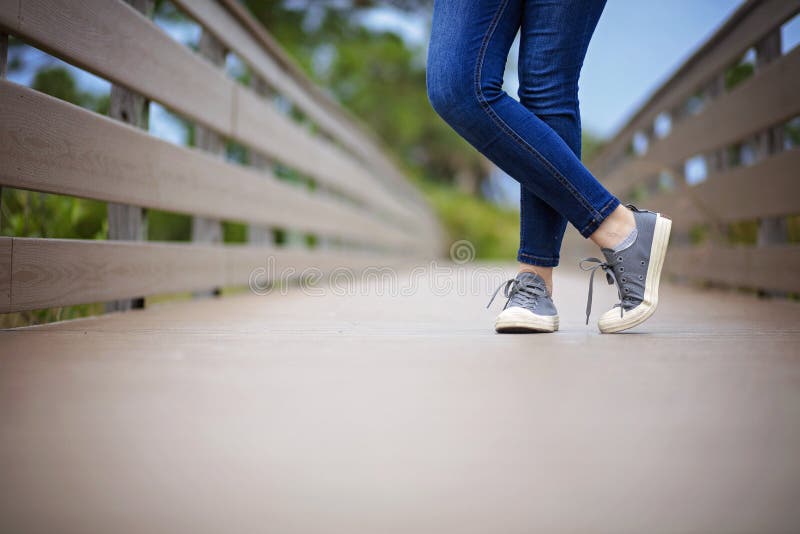 Converse Tennis Shoes Jeans Standing on Wooden Boardwalk Stock Image -  Image of wooden, boardwalk: 194085793
