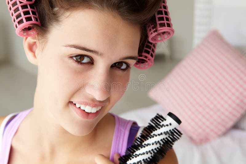 Teenage girl with hair in curlers