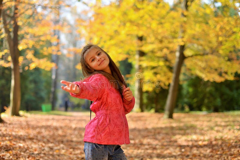 A teenage girl with her hair down walks in the forest Park in the autumn. stock photos A teenage girl with her hair down walks in the forest Park in the autumn. stock photos