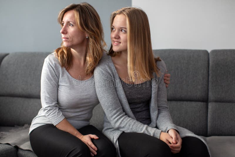 Teenage girl with her mother on a sofa stock image Teenage girl with her mother on a sofa stock image