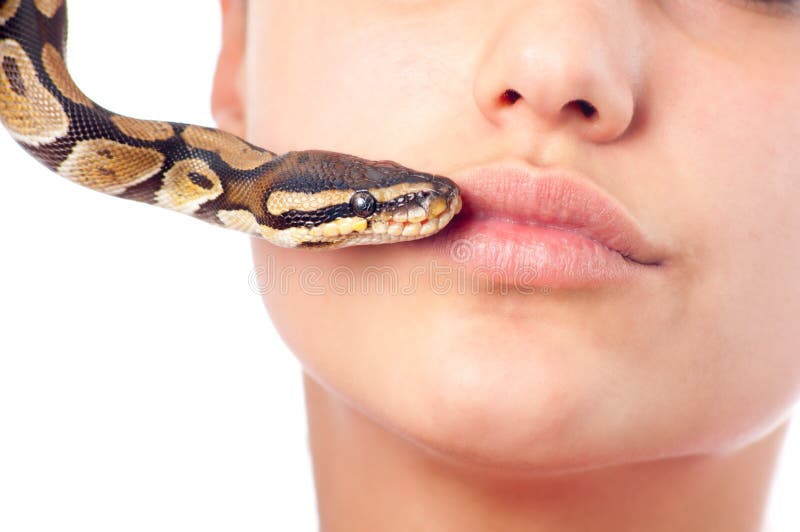 Teenage girl kissing pet python