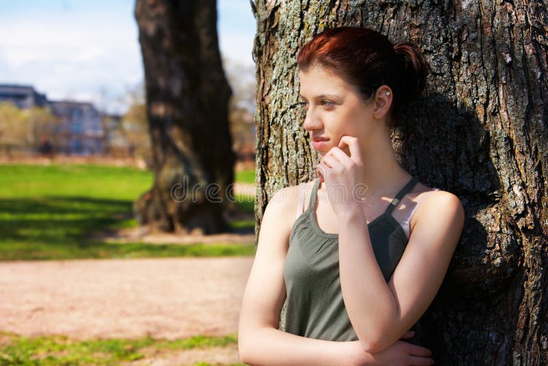 Teenage Girl Leaning to Tree