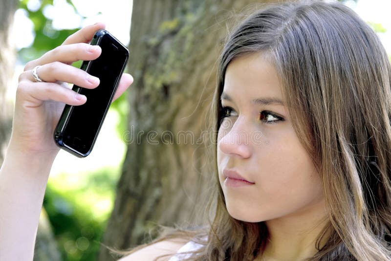 Teenage girl looking at mobile cell phone