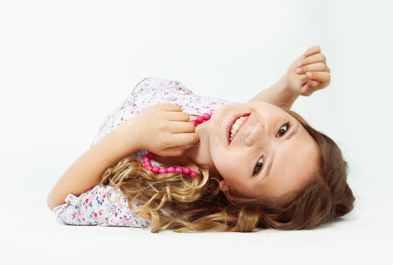 Teenage girl lying down, with jewellery on her neck