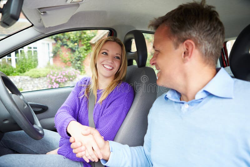Teenage Girl Passing Driving Test With Examiner royalty free stock photography Teenage Girl Passing Driving Test With Examiner royalty free stock photography