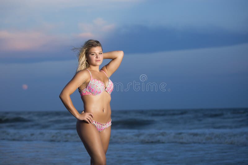 Teenager, girl in blue swimming suit on the beach Stock Photo