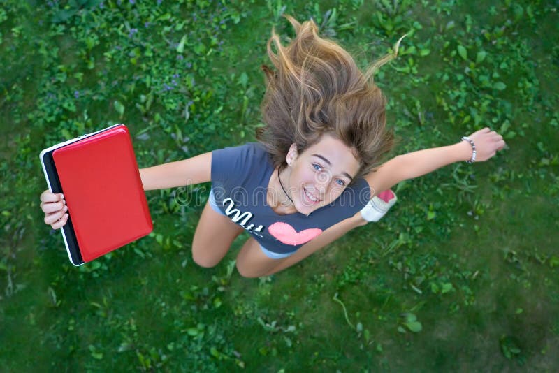 Teenage girl with red laptop