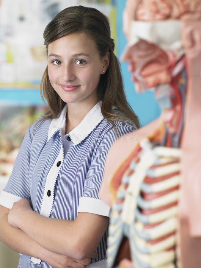 Portrait of high school student standing by anatomical model. Portrait of high school student standing by anatomical model