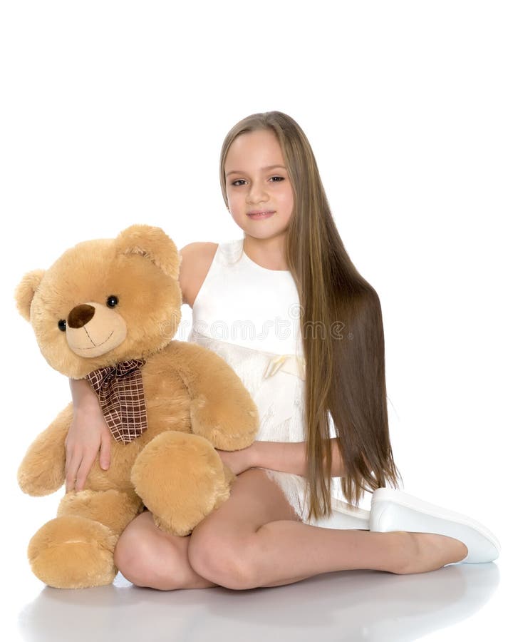 A teenage girl with a teddy bear. stock images