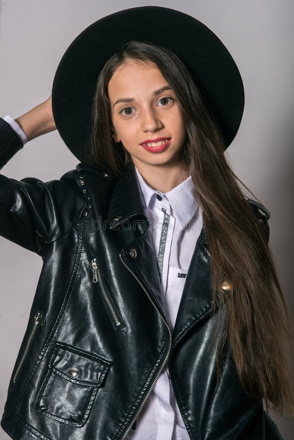 A Teenage Girl in a Trendy Leather Jacket and an Even Hat on a White ...