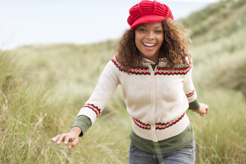 Teenage Girl Walking Through Sand Dunes