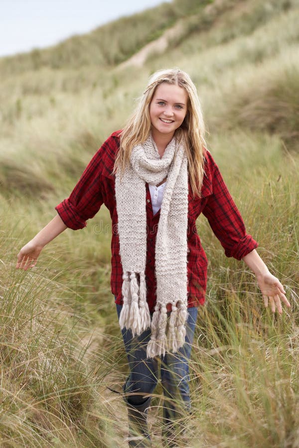 Teenage Girl Walking Through Sand Dunes